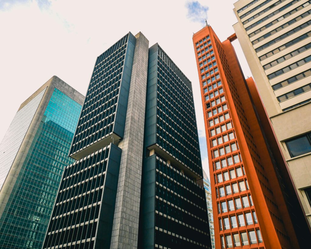 Low angle view of modern skyscrapers against a clear sky.